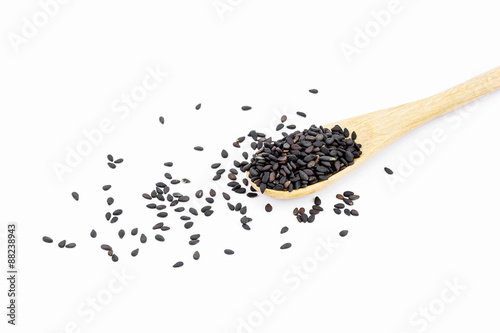 Black Sesame Seeds in wooden spoon isolated on white background