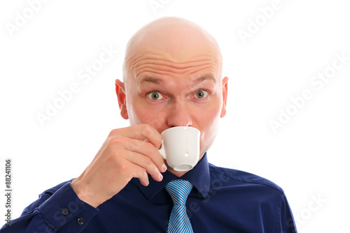 young man with bald head drinking espresso photo