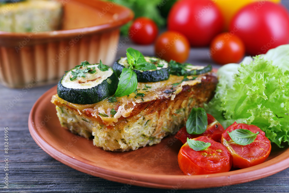 Casserole with vegetable mallow on wooden table, closeup Casserole with vegetable mallow on wooden table, closeup