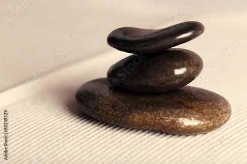 Zen garden with stones on sand background