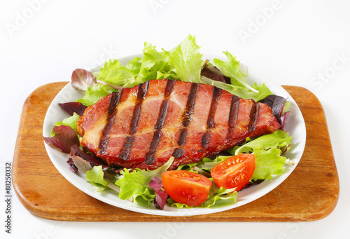 Grilled pork with salad greens