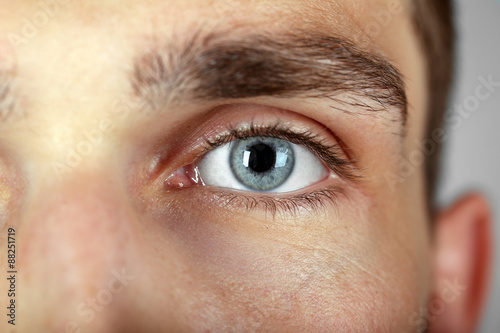 Beautiful blue man eye close up