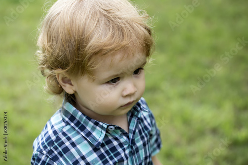 Boy child on green grass