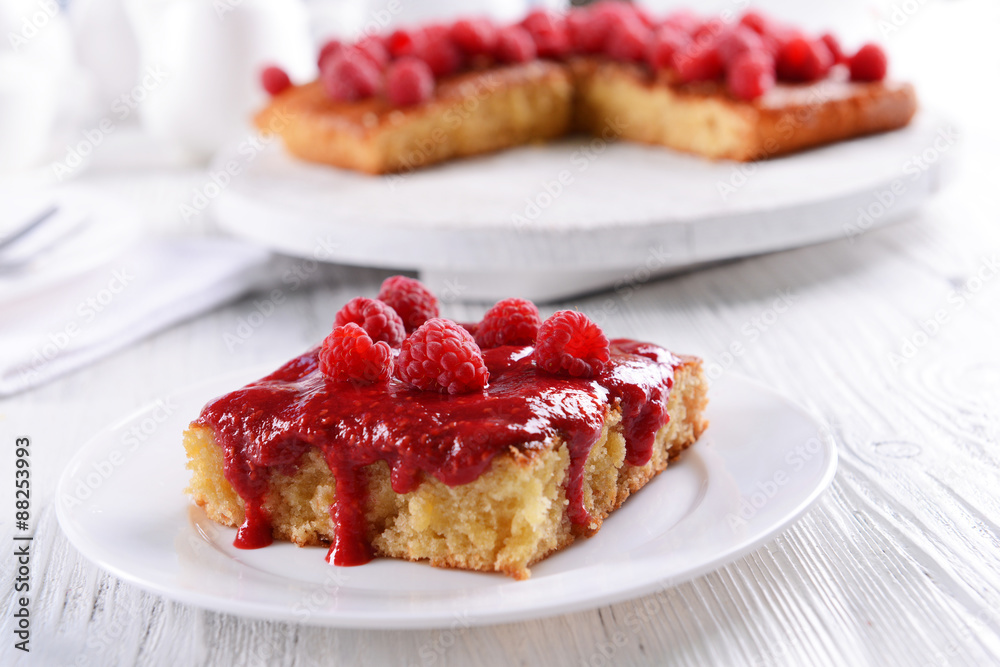 Fresh pie with raspberry jam in white saucer on wooden table, closeup Fresh pie with raspberry jam in white saucer on wooden table, closeup