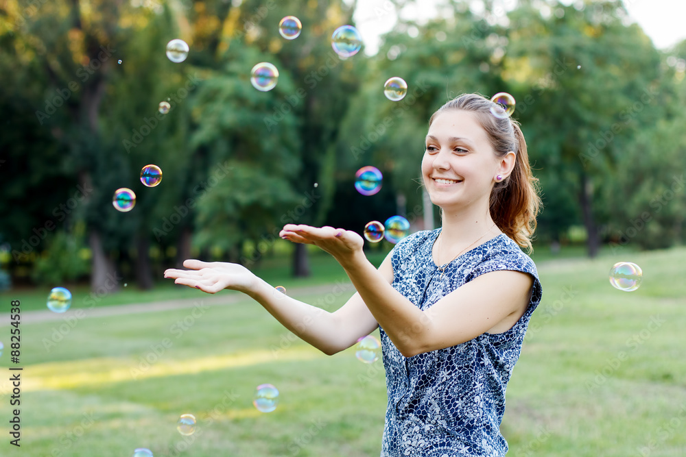 Beautiful girl in the park with soap bubbles. Beautiful girl in the park with soap bubbles.