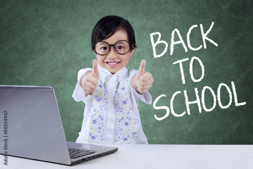 Lovely child back to school and show OK sign Lovely child back to school and show OK sign