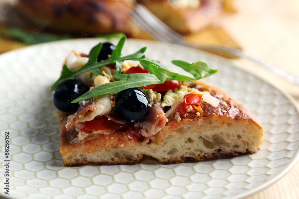 Pieces of homemade pizza on plate, close-up Pieces of homemade pizza on plate, close-up