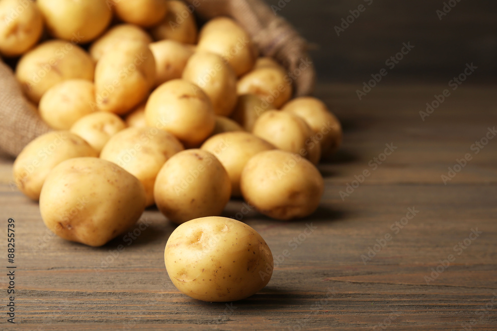 New potatoes on wooden background New potatoes on wooden background