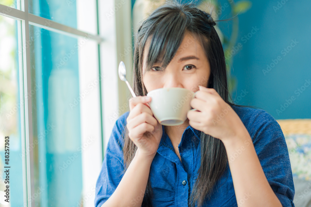 Beautiful young woman with a white cup of coffee Beautiful young woman with a white cup of coffee