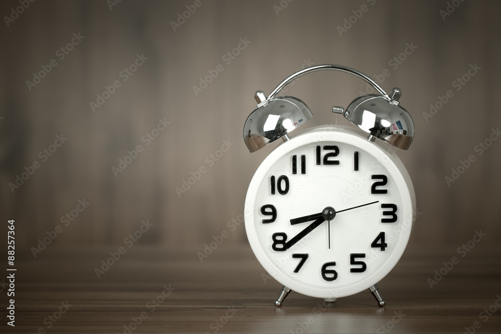 white alarm clock on wooden old background, red vintage clock on white alarm clock on wooden old background, red vintage clock on