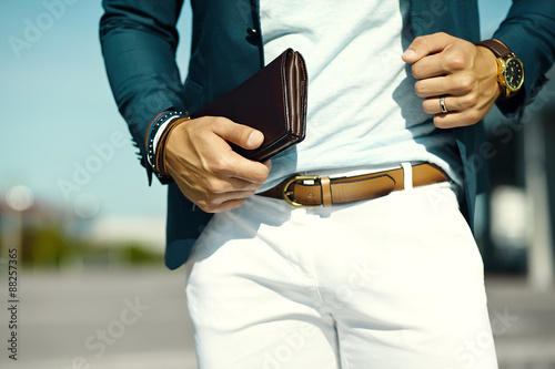 Fashion portrait of young businessman handsome  model man in casual cloth suit with accesories on hands © halayalex