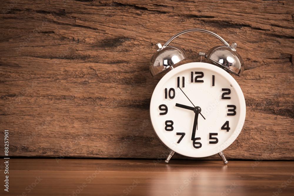 white alarm clock on wooden old background, red vintage clock on white alarm clock on wooden old background, red vintage clock on