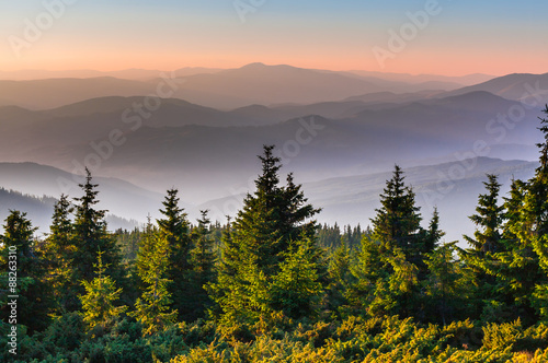 Fototapeta Naklejka Na Ścianę i Meble -  Distant mountain range and thin layer of clouds on the valleys