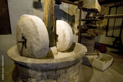 Ancient olive oil production machinery, stone mill and mechanical press photo