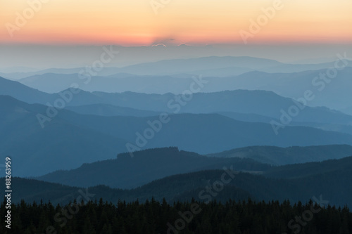 Distant mountain range and thin layer of clouds on the valleys © Dmytro Kosmenko