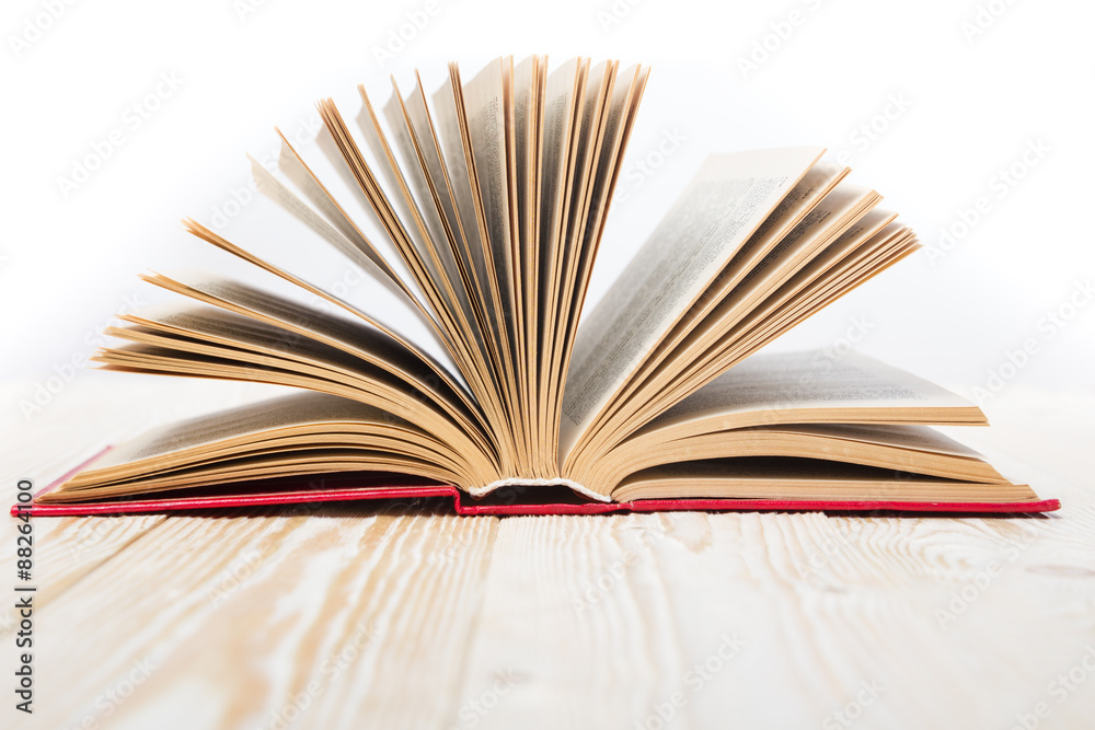 Fototapeta premium Open book on wooden table. Back to school. Copy space
