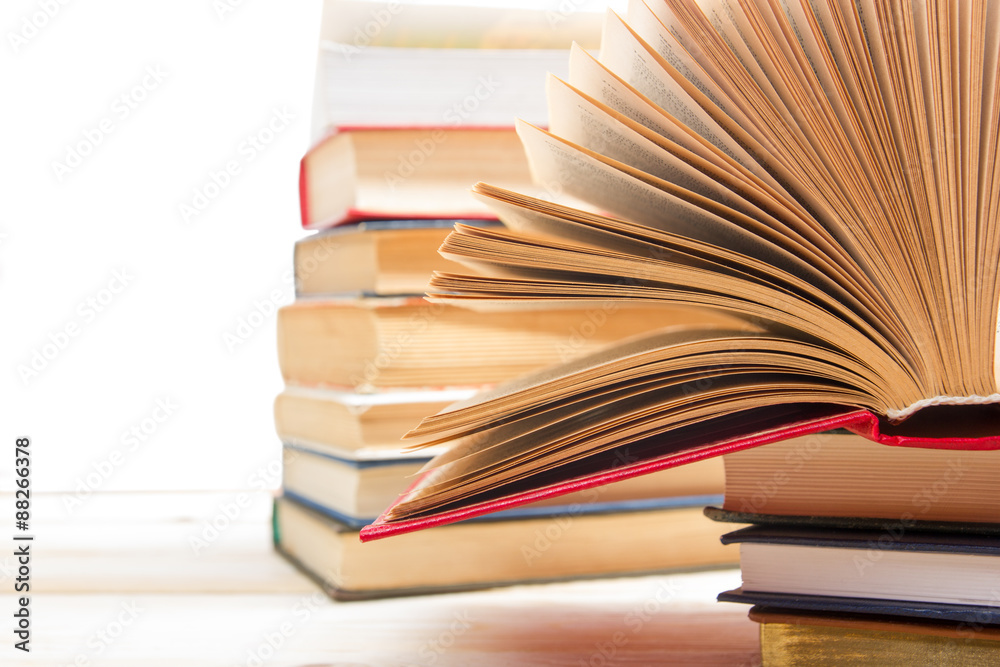 Fototapeta premium Stack of books on wooden table isolated on white background. Back to school. Copy space