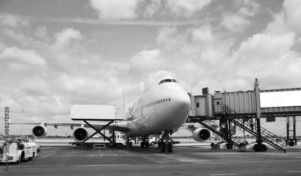 Airplane near the terminal in an airport Airplane near the terminal in an airport