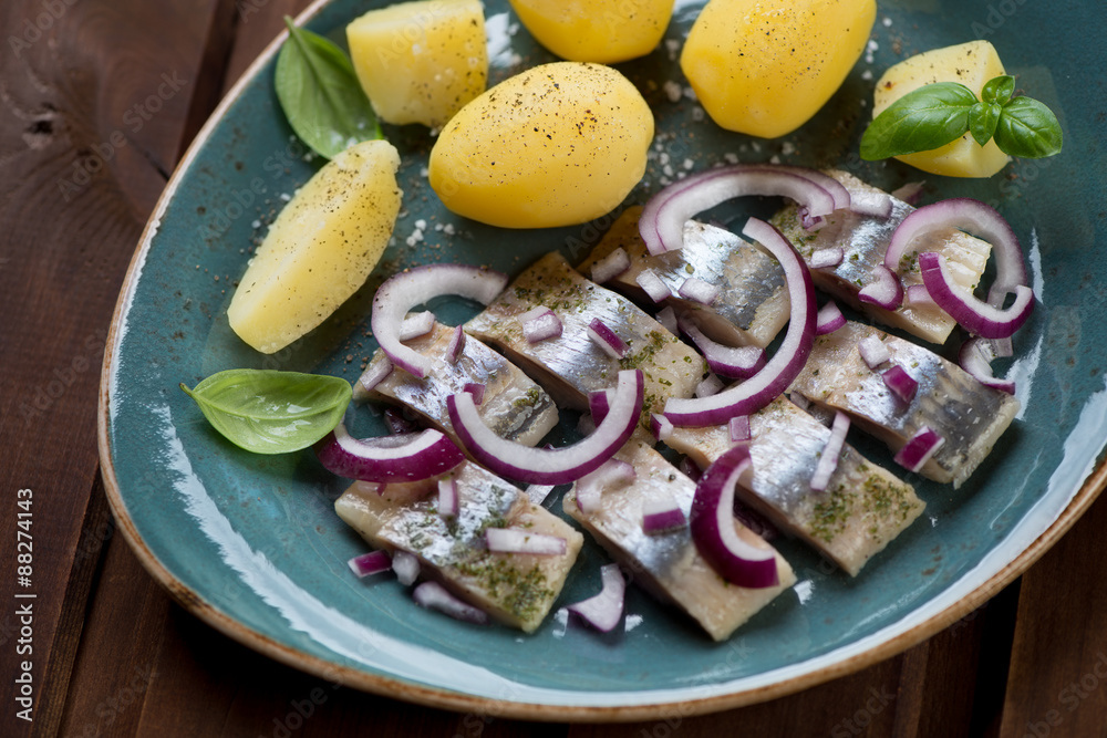Close-up of sliced herring fillet with red onion and potatoes Close-up of sliced herring fillet with red onion and potatoes