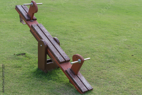 Wooden Teeter totter in public playground photo