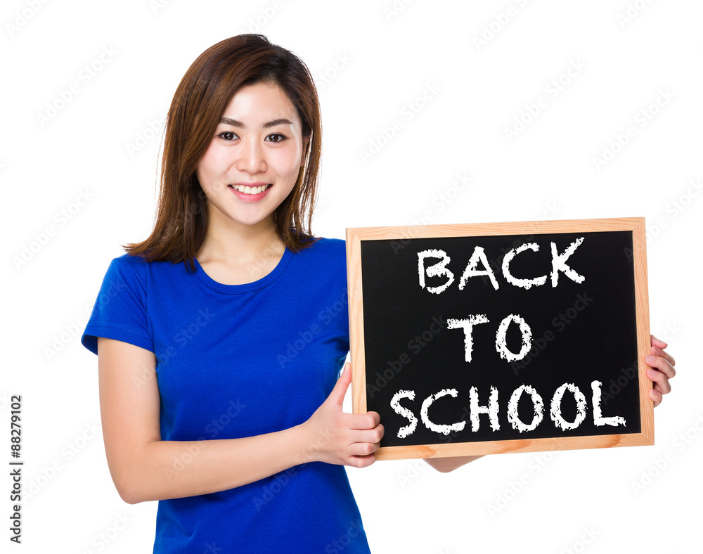 Young woman with blackboard showing phrase of back to school