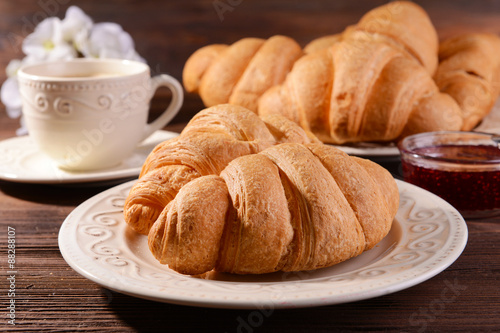 Delicious croissants on plate on table close-up