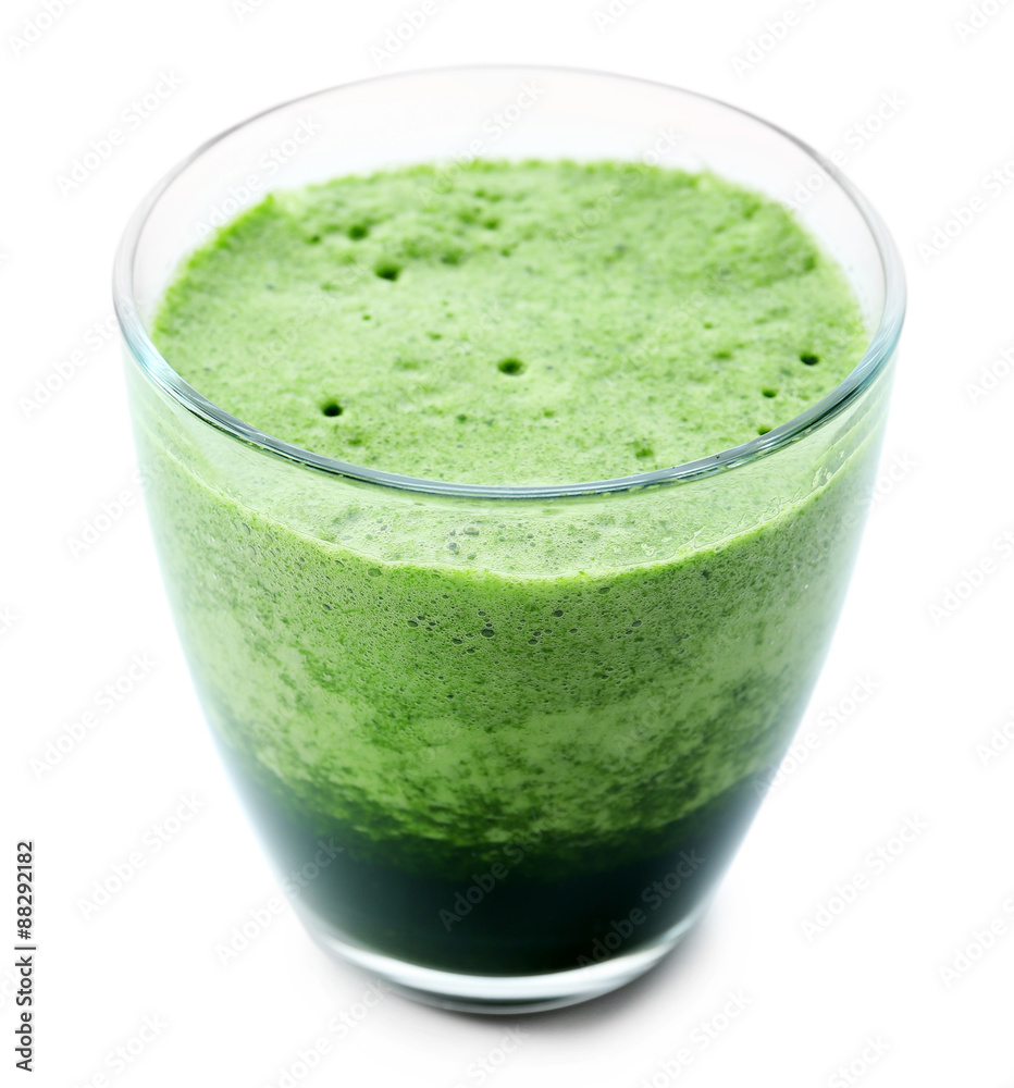 Glass of green vegetable juice isolated on white