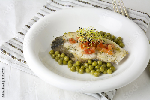 Hake fillet with tomato and sprouts,