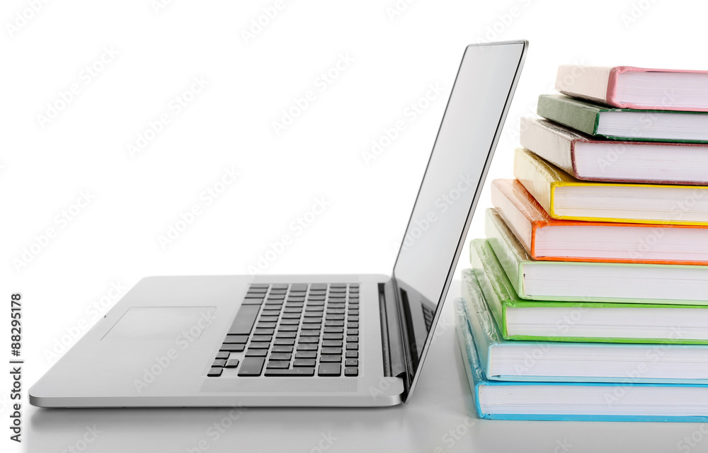 Stack of books with laptop isolated on white Stack of books with laptop isolated on white