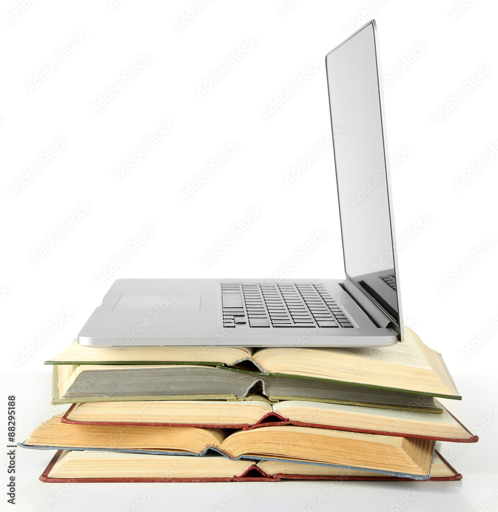 Stack of books with laptop isolated on white Stack of books with laptop isolated on white