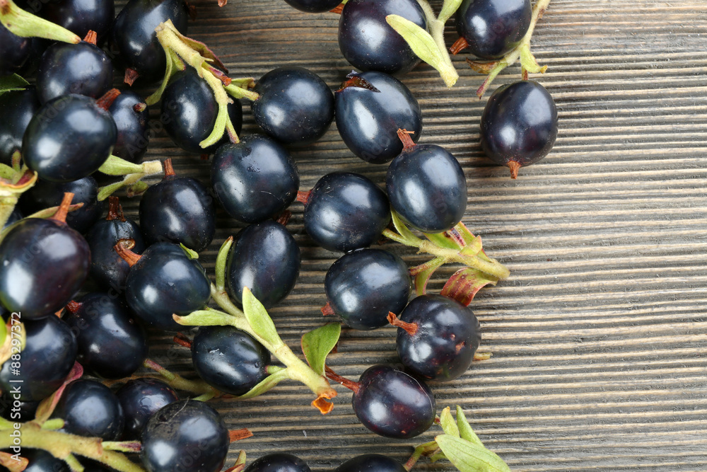 Pile of black currants on wooden table, closeup Pile of black currants on wooden table, closeup