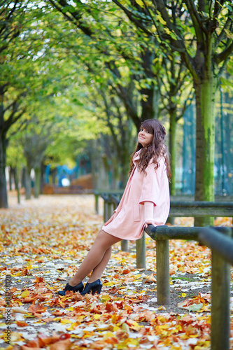 Beautiful young Parisian woman enjoying bright fall day photo