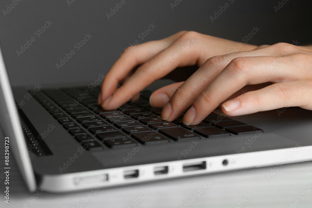 Female hands typing on laptop keyboard, closeup Female hands typing on laptop keyboard, closeup