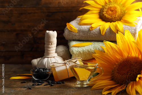 Fototapeta Naklejka Na Ścianę i Meble -  Spa treatments and sunflower on wooden background