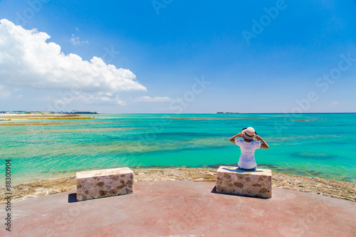沖縄の海と空を見つめる女性 © imacoconut