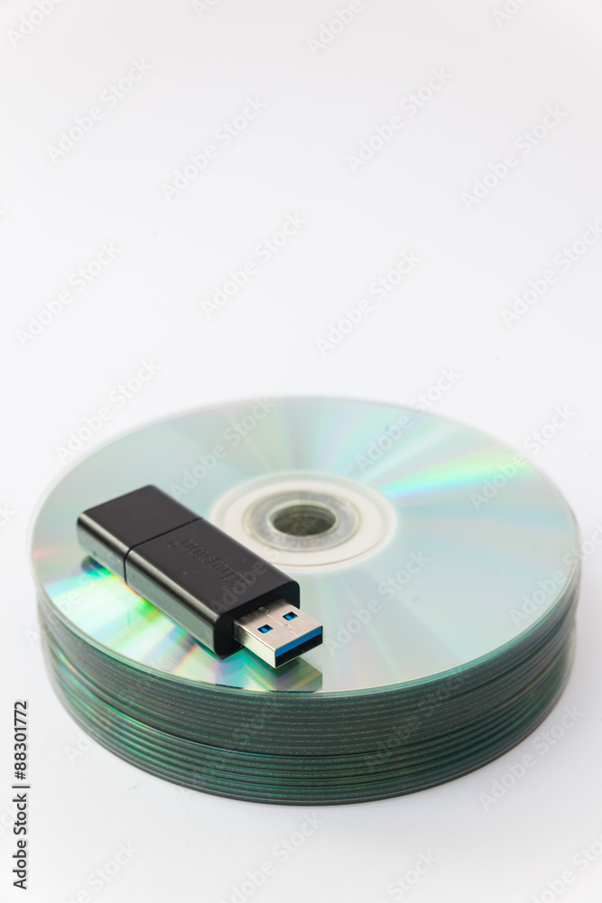 Usb flash drives on stacked CDs isolate on white background. Usb flash drives on stacked CDs isolate on white background.