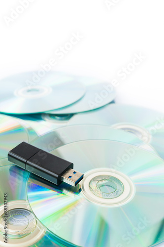 Usb flash drives on stacked CDs isolate on white background.