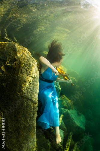 The girl with a violin under water