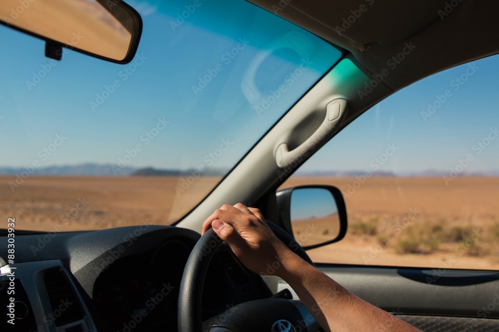 view of a man driving through the desert