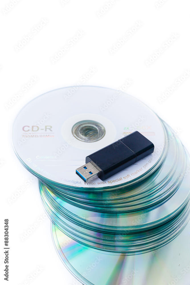 Usb flash drives on stacked CDs isolate on white background. Usb flash drives on stacked CDs isolate on white background.