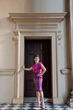 Woman in Thai silk traditional dress stand in old building