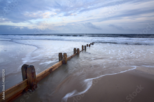 Groynes and receding tide on Alnmouth Beach at dusk, Northumberland