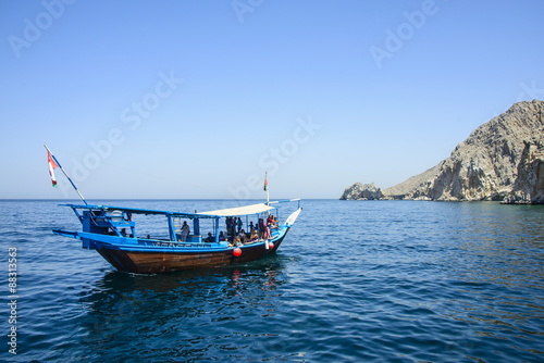 Tourist boat in form of a dhow sailing in the Khor ash-sham fjord, Musandam, Oman photo