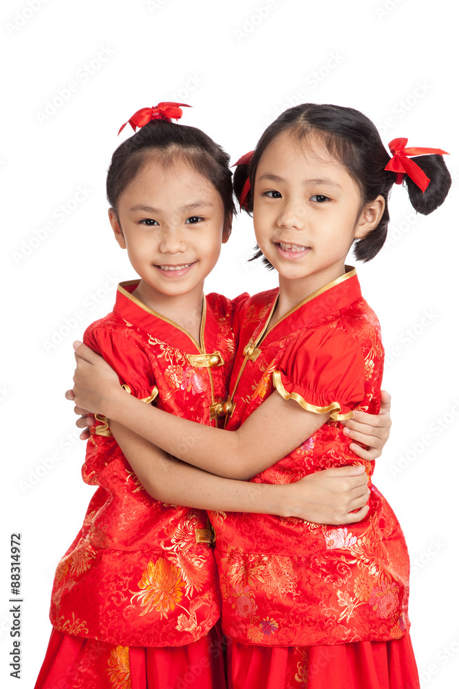 Happy Asian twins girls in chinese cheongsam dress Happy Asian twins girls in chinese cheongsam dress
