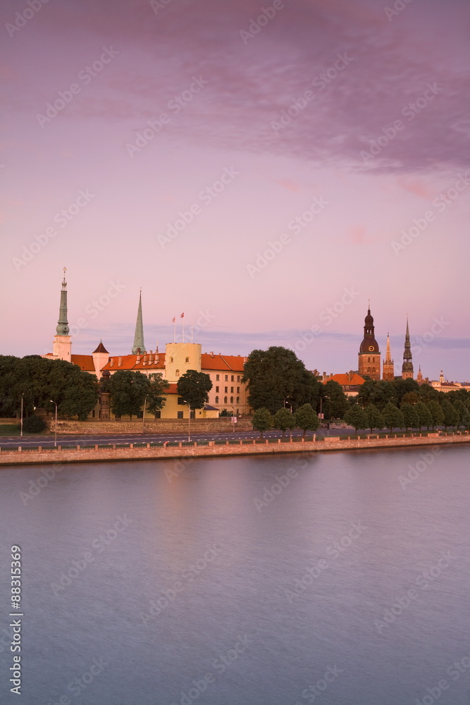 Riga Castle and the River Daugava illuminated at sunset, Riga, Latvia Riga Castle and the River Daugava illuminated at sunset, Riga, Latvia