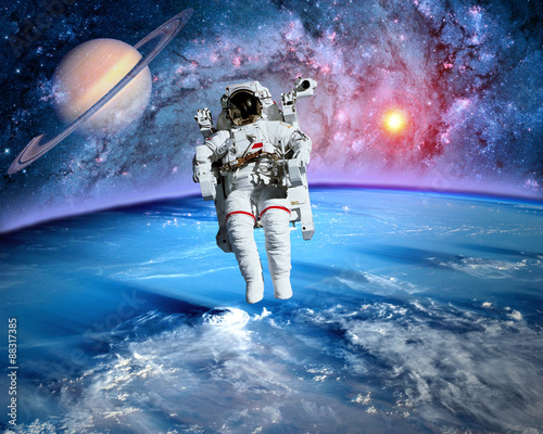 Fototapeta Naklejka Na Ścianę i Meble -  Astronaut spaceman outer space planet saturn earth sun universe. Elements of this image furnished by NASA.