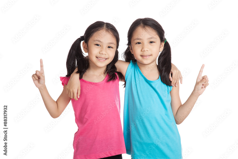 Happy Asian twins girls smile show one finger Happy Asian twins girls smile show one finger