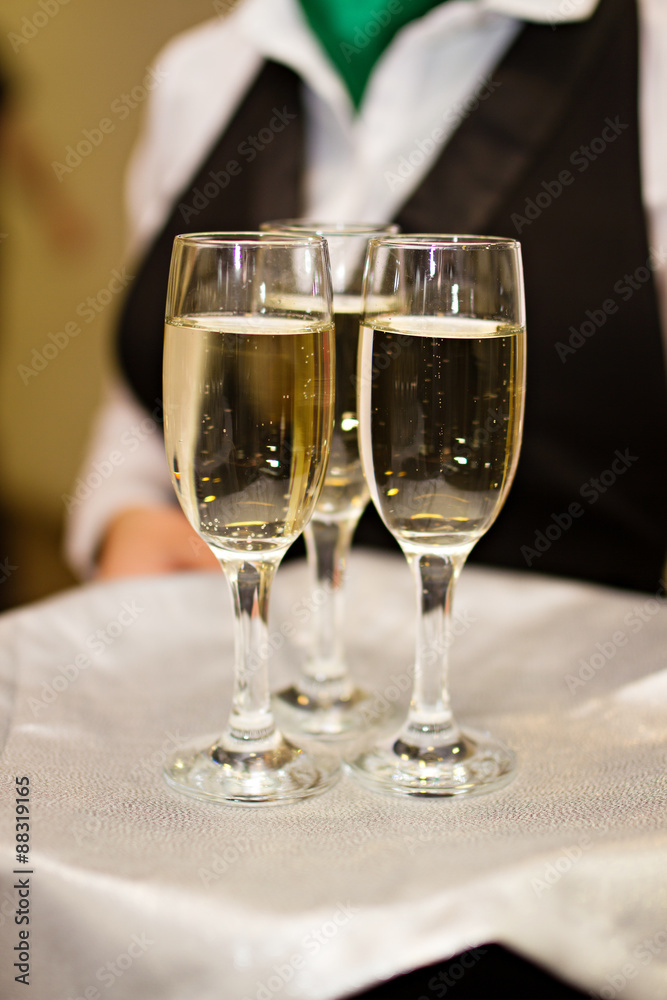 Three glasses of Champagne and a waiter Three glasses of Champagne and a waiter