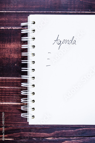 Concept of agenda record,notebook on wooden background