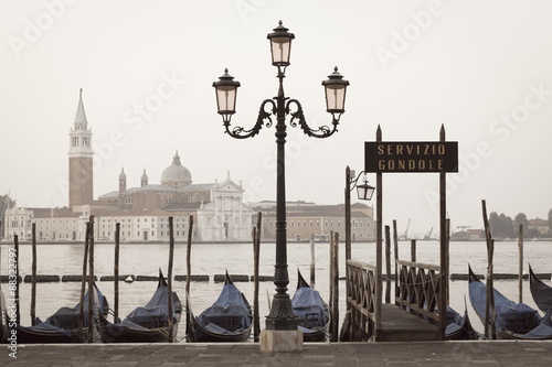 Gondolas moored on the Lagoon, San Giorgio Maggiore beyond, Riva degli Schiavoni, Venice, Veneto